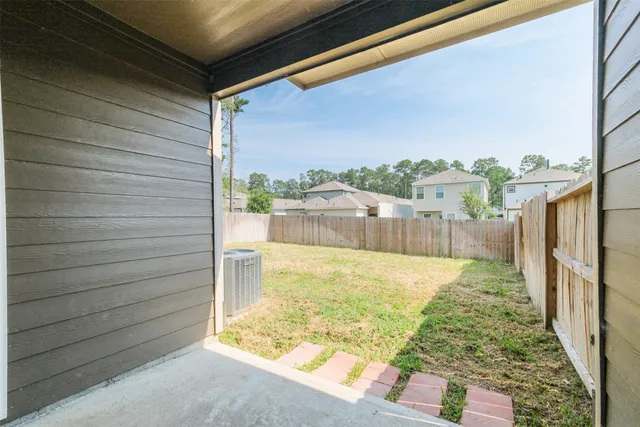 a view of back yard of the house with an outdoor space