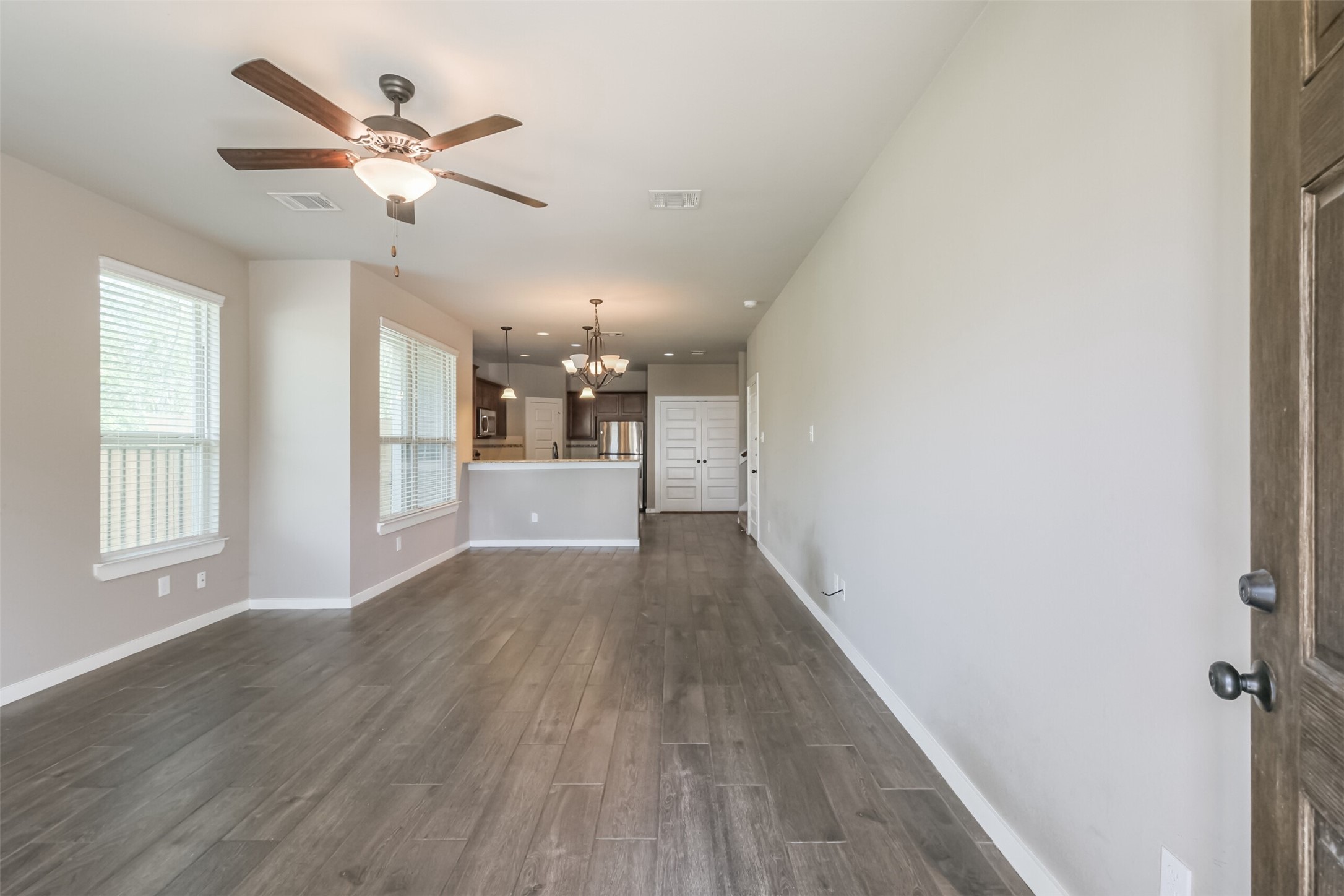 121 Wickersham, Unit A Conroe, TX 77304 - Photo 4 of 37 a view of a livingroom with a ceiling fan & wooden floor