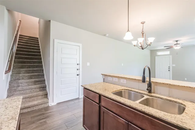 a close view of a sink a faucet and a refrigerator