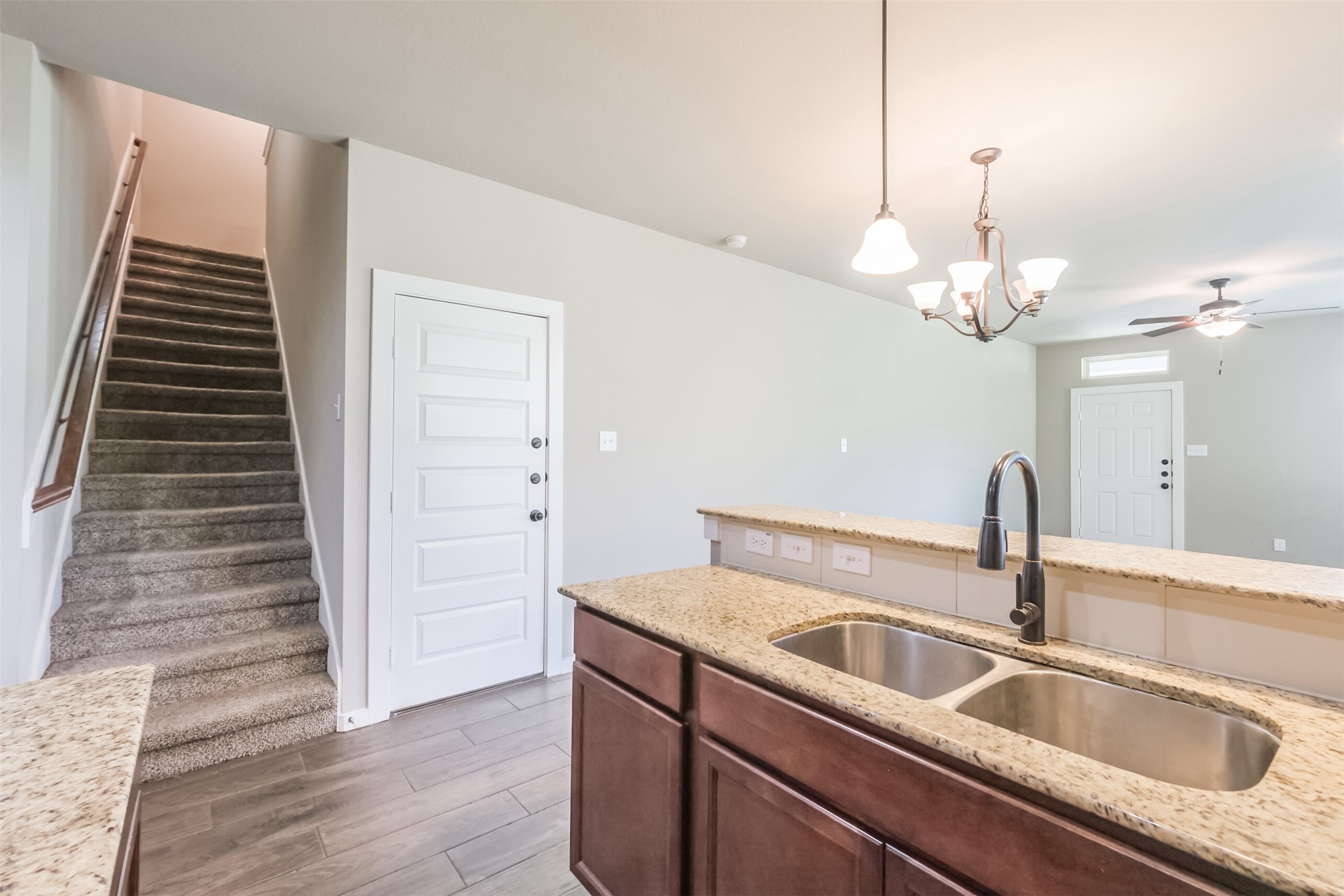 121 Wickersham, Unit A Conroe, TX 77304 - Photo 8 of 37 a close view of a sink a faucet and a refrigerator