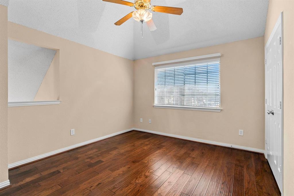 14588 Poe Court Addison, TX 75001 - Photo 25 of 28 a view of an empty room with wooden floor and a window