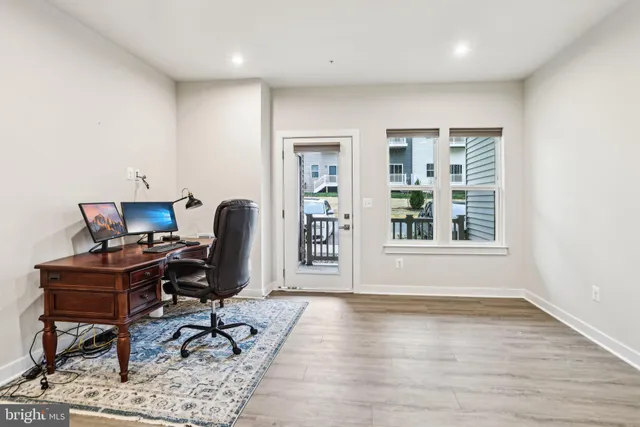 a view of workspace with wooden floor windows