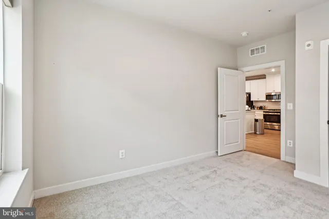 an empty room with a kitchen and a sink