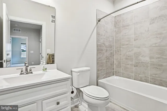 a bathroom with a sink a toilet and a bathtub
