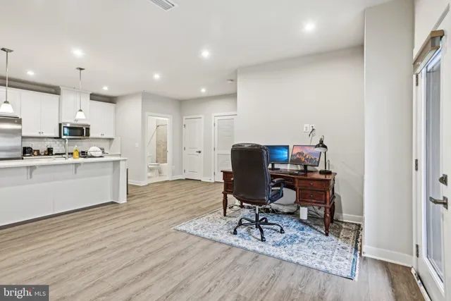 a view of kitchen with microwave stove refrigerator dining table and chair
