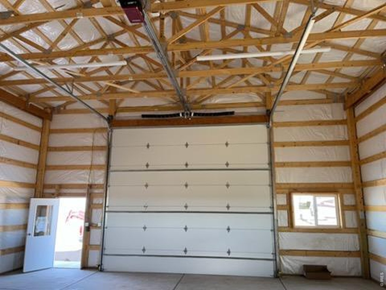 13550 Deter-Winters Road Byers, CO 80103 - Photo 11 of 50 The 14' insulated remote control powered overhead door in the barn is very convenient feature