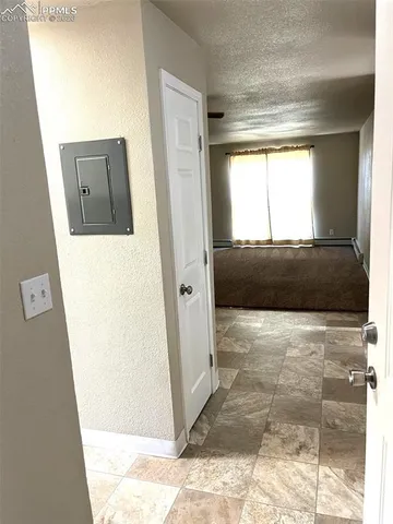 an empty room with windows and closet