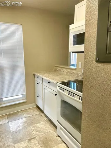 a view of a kitchen with washer and dryer