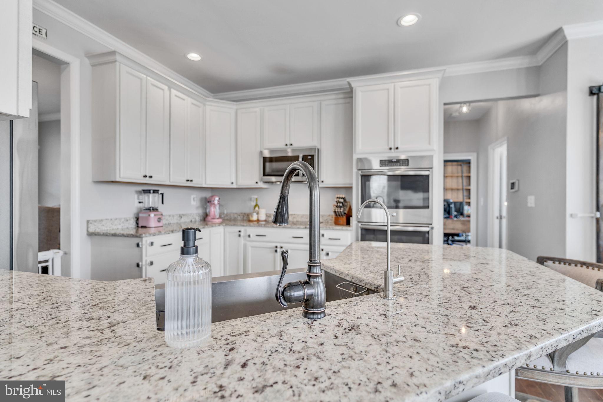 1935 Lowery Road Huntingtown, MD 20639 - Photo 18 of 65 a kitchen with stainless steel appliances kitchen island granite countertop a sink and cabinets