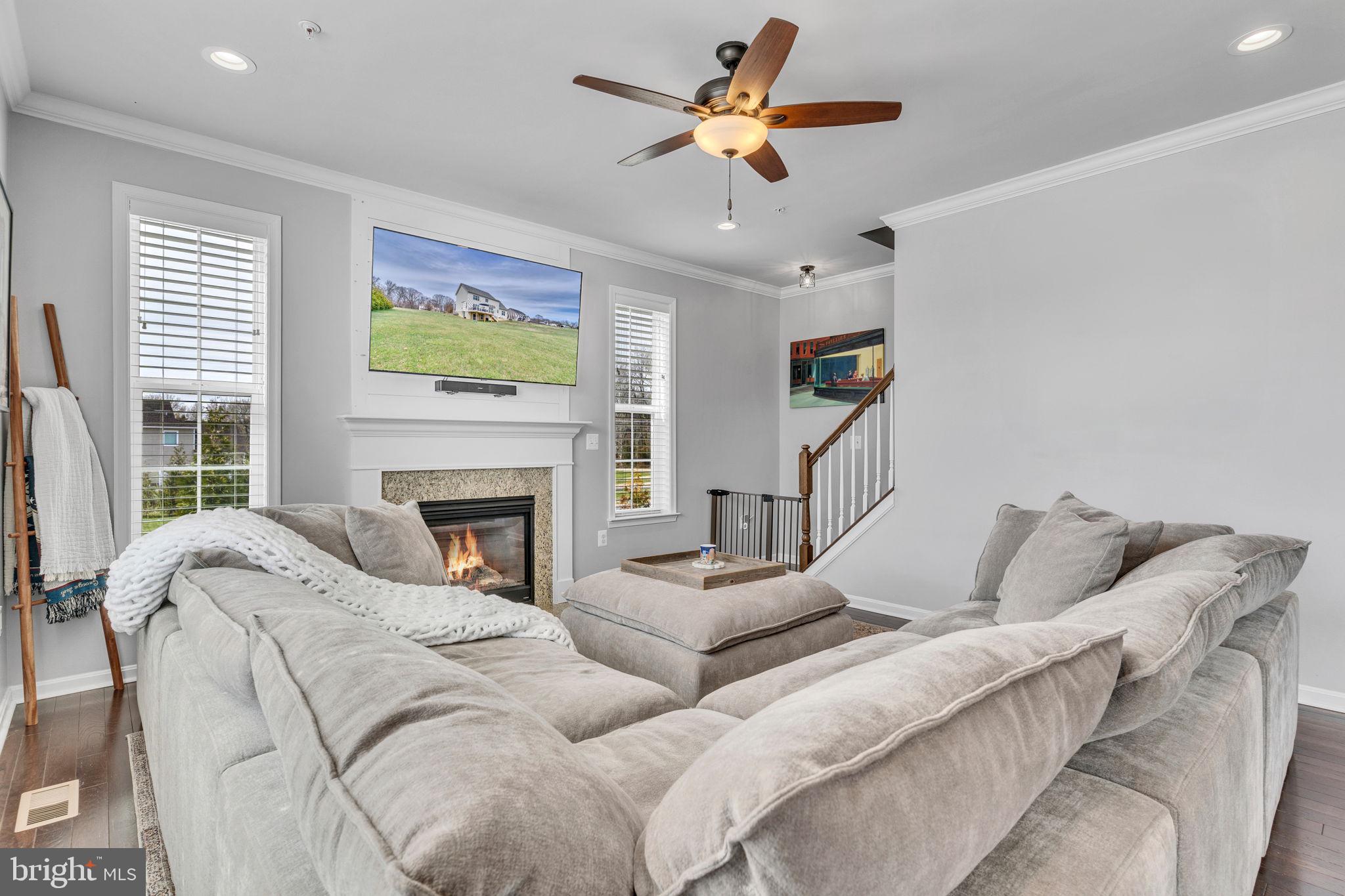 1935 Lowery Road Huntingtown, MD 20639 - Photo 28 of 65 a living room with furniture ceiling fan and a fireplace