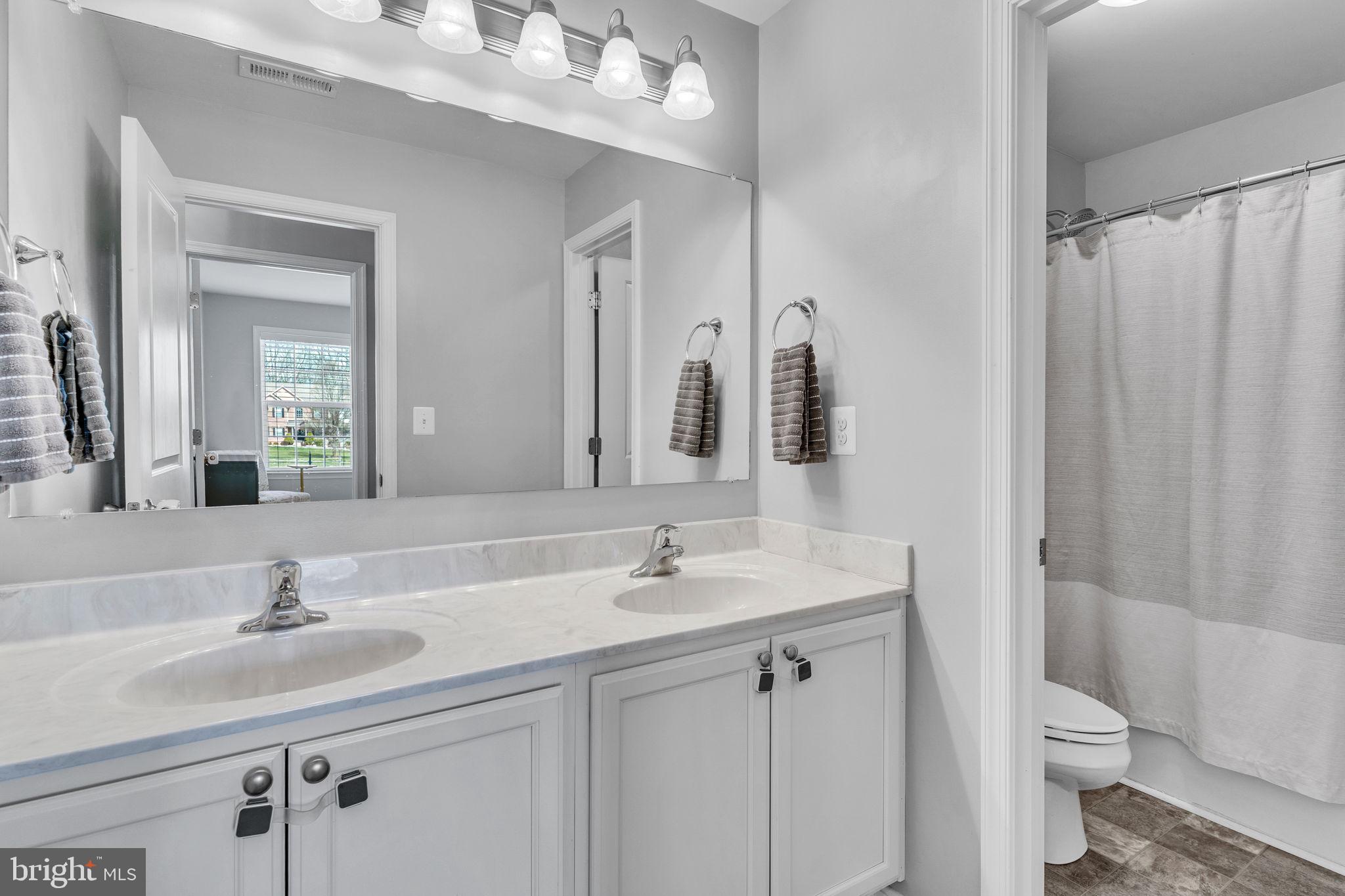1935 Lowery Road Huntingtown, MD 20639 - Photo 41 of 65 a bathroom with a sink toilet a mirror and shower