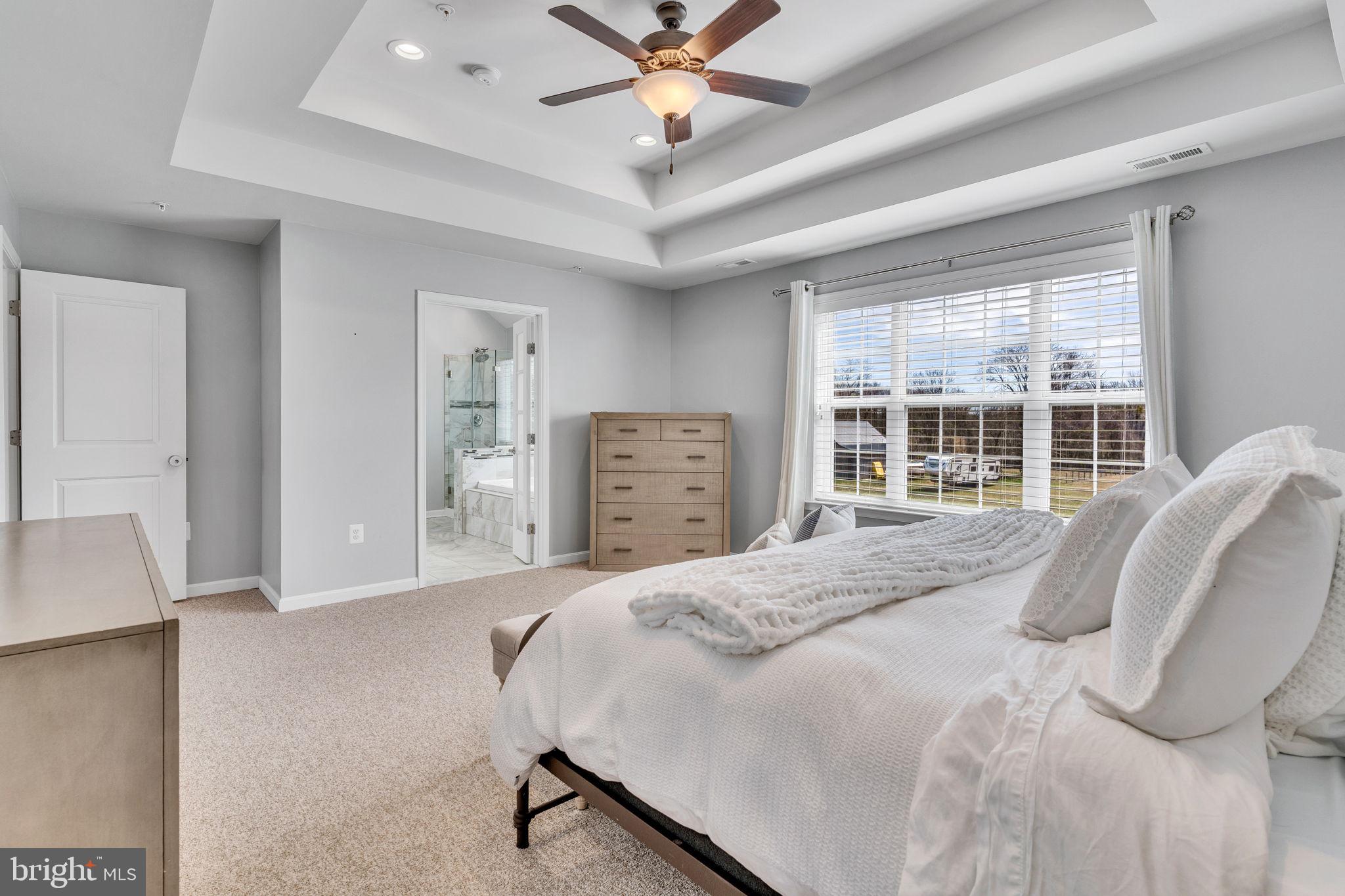 1935 Lowery Road Huntingtown, MD 20639 - Photo 47 of 65 a bedroom with a bed and dresser with floor to ceiling window