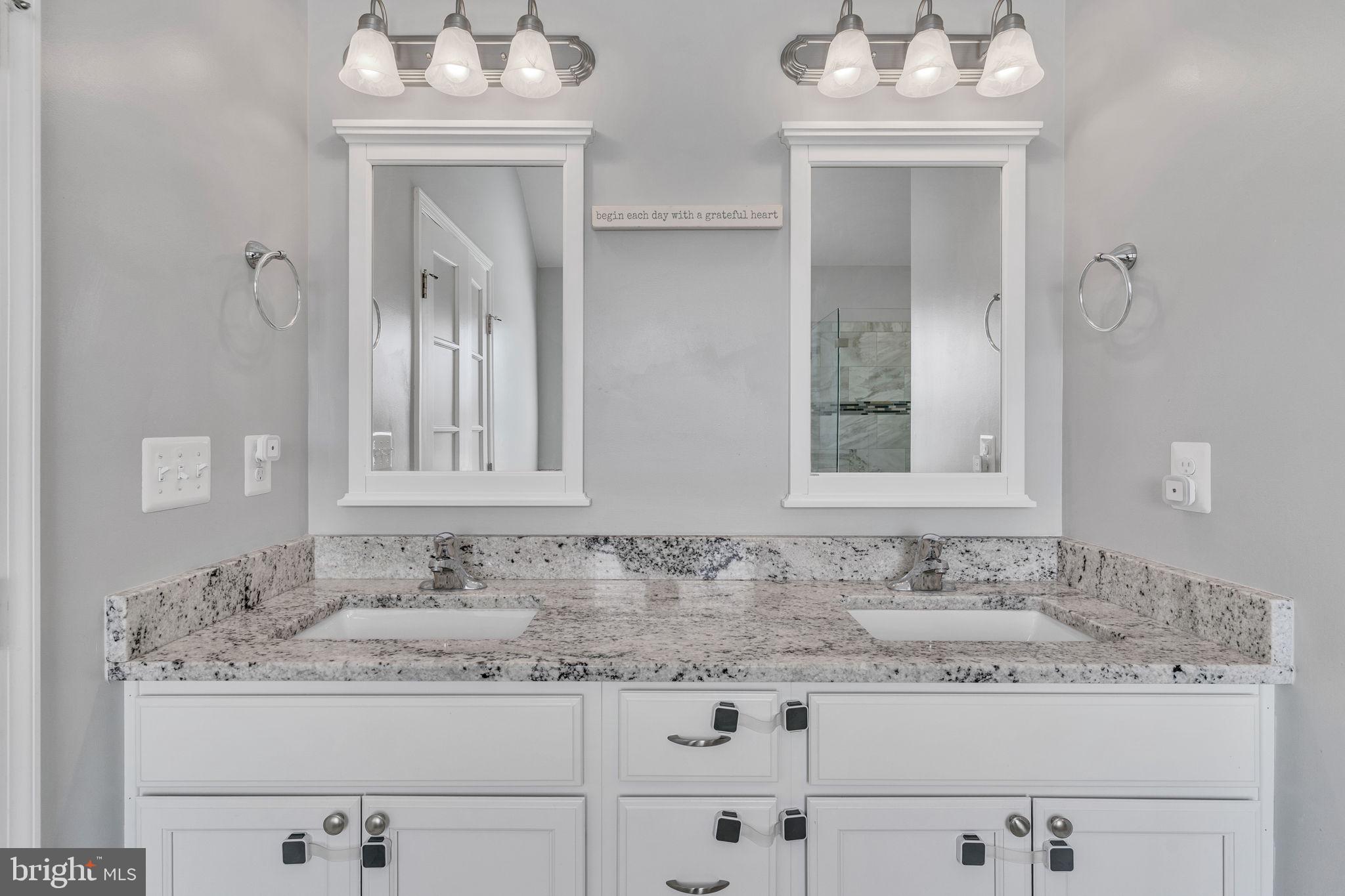 1935 Lowery Road Huntingtown, MD 20639 - Photo 48 of 65 a bathroom with granite countertop white cabinets and a sink