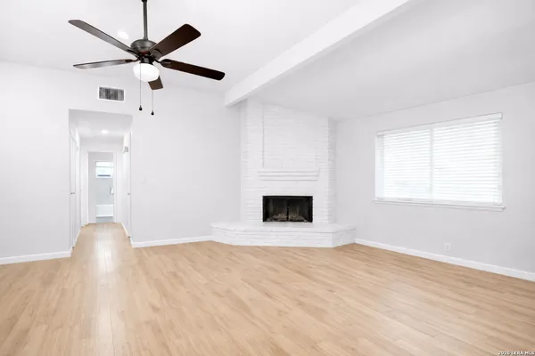 wooden floor in an empty room with a fireplace