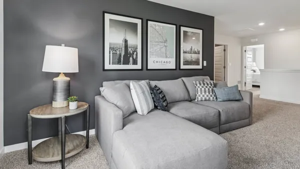 a living room with furniture and a lamp