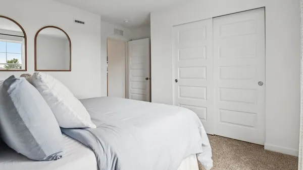 a bedroom with a bed and a dresser