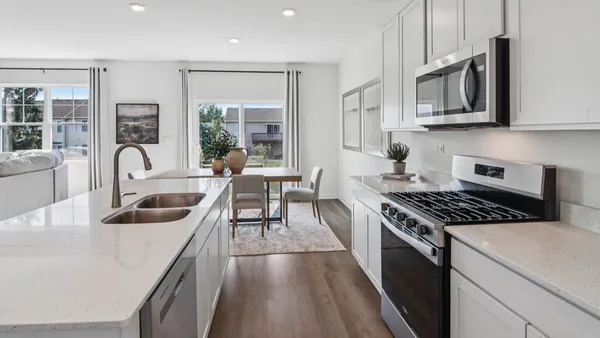 a kitchen with granite countertop stainless steel appliances a stove a sink and a cabinets