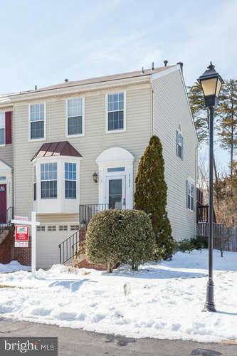 21053 Cornerpost Square Ashburn, VA 20147 - Photo 2 of 30 a view of a house with snow on the background