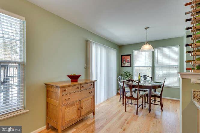 21053 Cornerpost Square Ashburn, VA 20147 - Photo 12 of 30 a dining room with furniture window and wooden floor