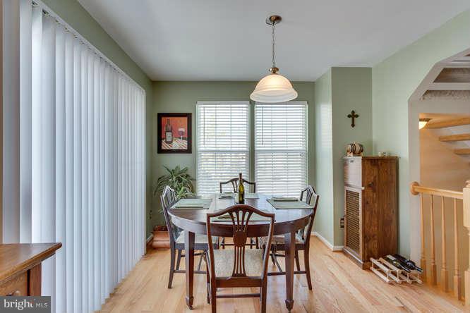 21053 Cornerpost Square Ashburn, VA 20147 - Photo 13 of 30 a dining room with furniture window and wooden floor