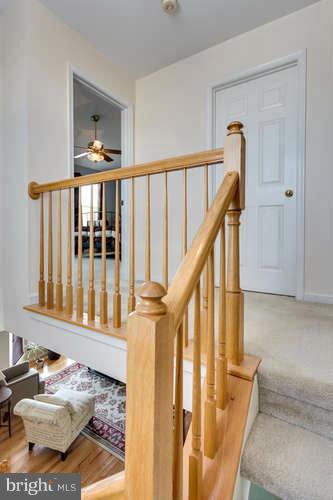 21053 Cornerpost Square Ashburn, VA 20147 - Photo 14 of 30 a view of a hallway with wooden floor and entryway