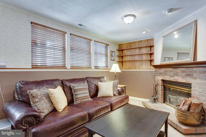 21053 Cornerpost Square Ashburn, VA 20147 - Photo 23 of 30 a living room with furniture and a fireplace