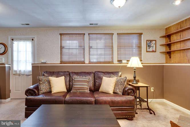 21053 Cornerpost Square Ashburn, VA 20147 - Photo 24 of 30 a living room with furniture and a window