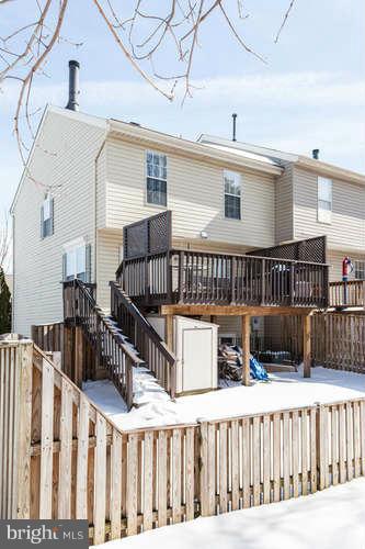 21053 Cornerpost Square Ashburn, VA 20147 - Photo 29 of 30 a view of a house with wooden fence