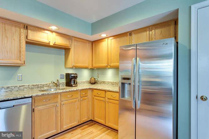 21053 Cornerpost Square Ashburn, VA 20147 - Photo 10 of 30 a kitchen with a refrigerator a sink and cabinets