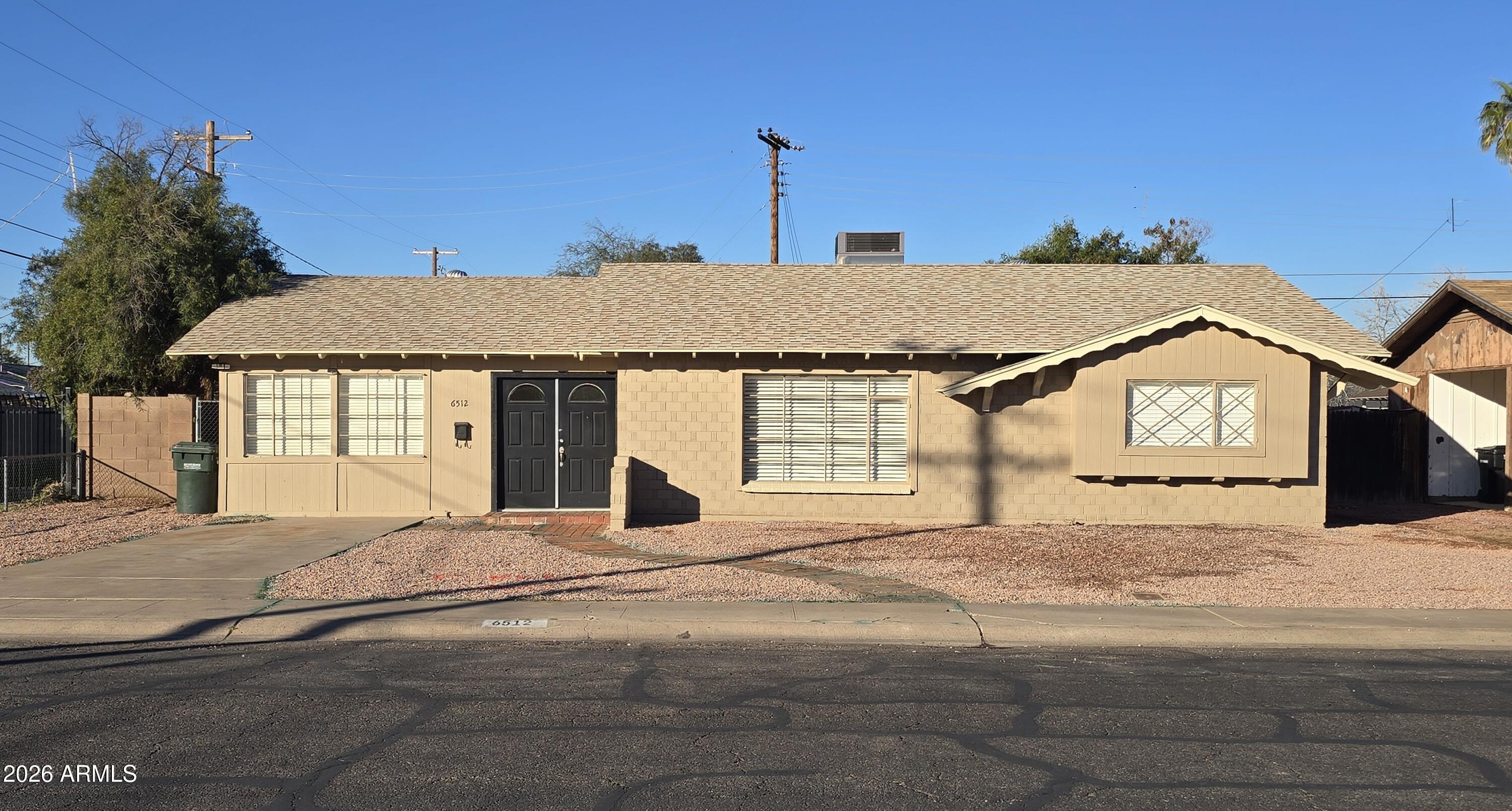 6512 North 41st Avenue Phoenix, AZ 85019 - Photo 1 of 24 a view of a house with a snow on the road