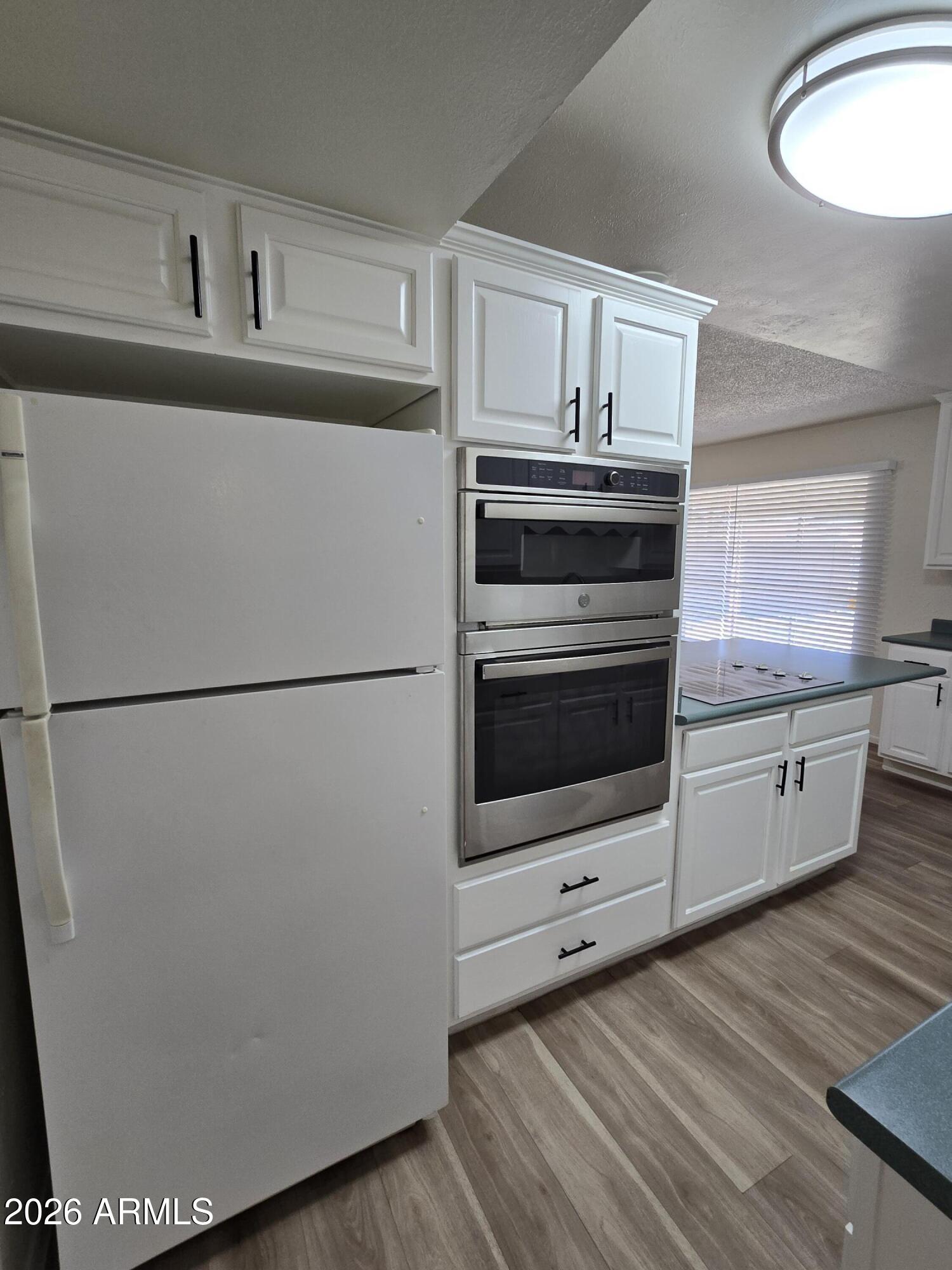 6512 North 41st Avenue Phoenix, AZ 85019 - Photo 11 of 24 a kitchen with stainless steel appliances a refrigerator sink and cabinets