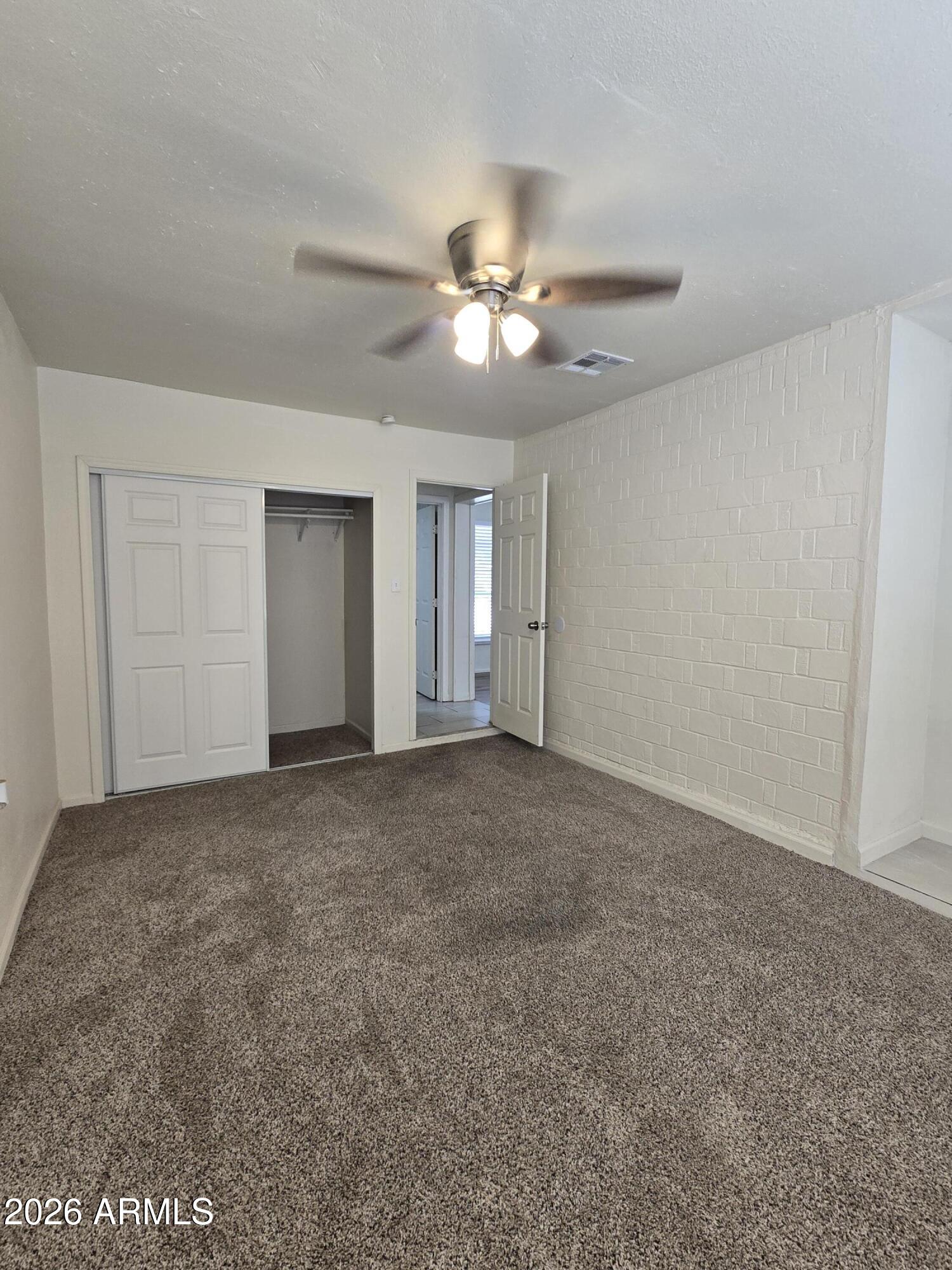 6512 North 41st Avenue Phoenix, AZ 85019 - Photo 15 of 24 a view of an empty room with a ceiling fan