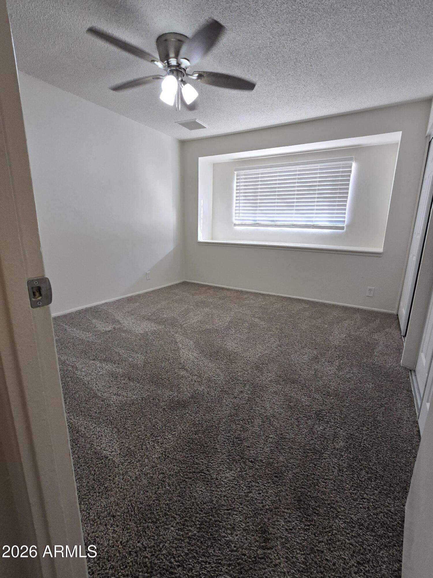 6512 North 41st Avenue Phoenix, AZ 85019 - Photo 18 of 24 a view of an empty room with a window