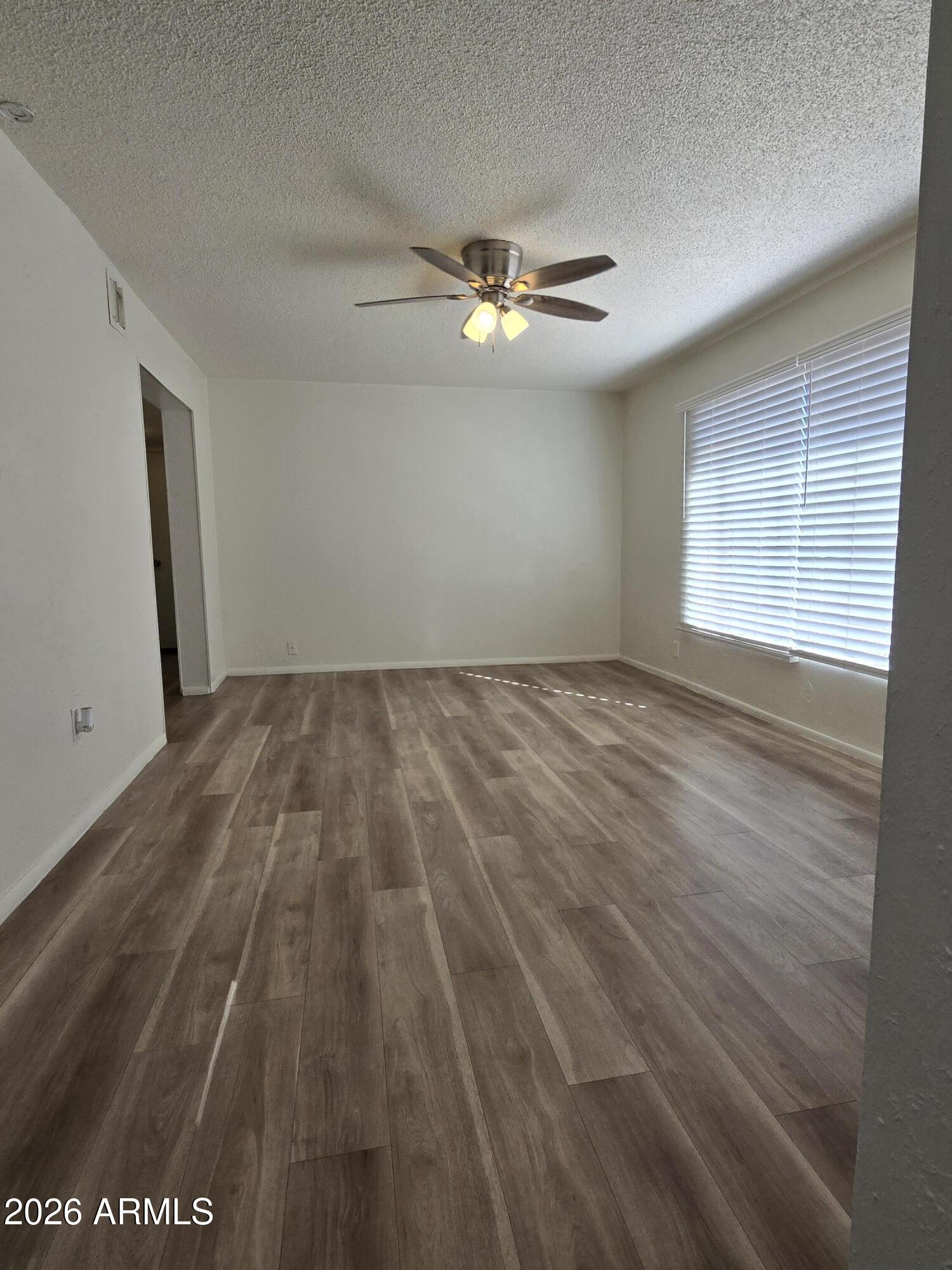 6512 North 41st Avenue Phoenix, AZ 85019 - Photo 2 of 24 a view of empty room with wooden floor