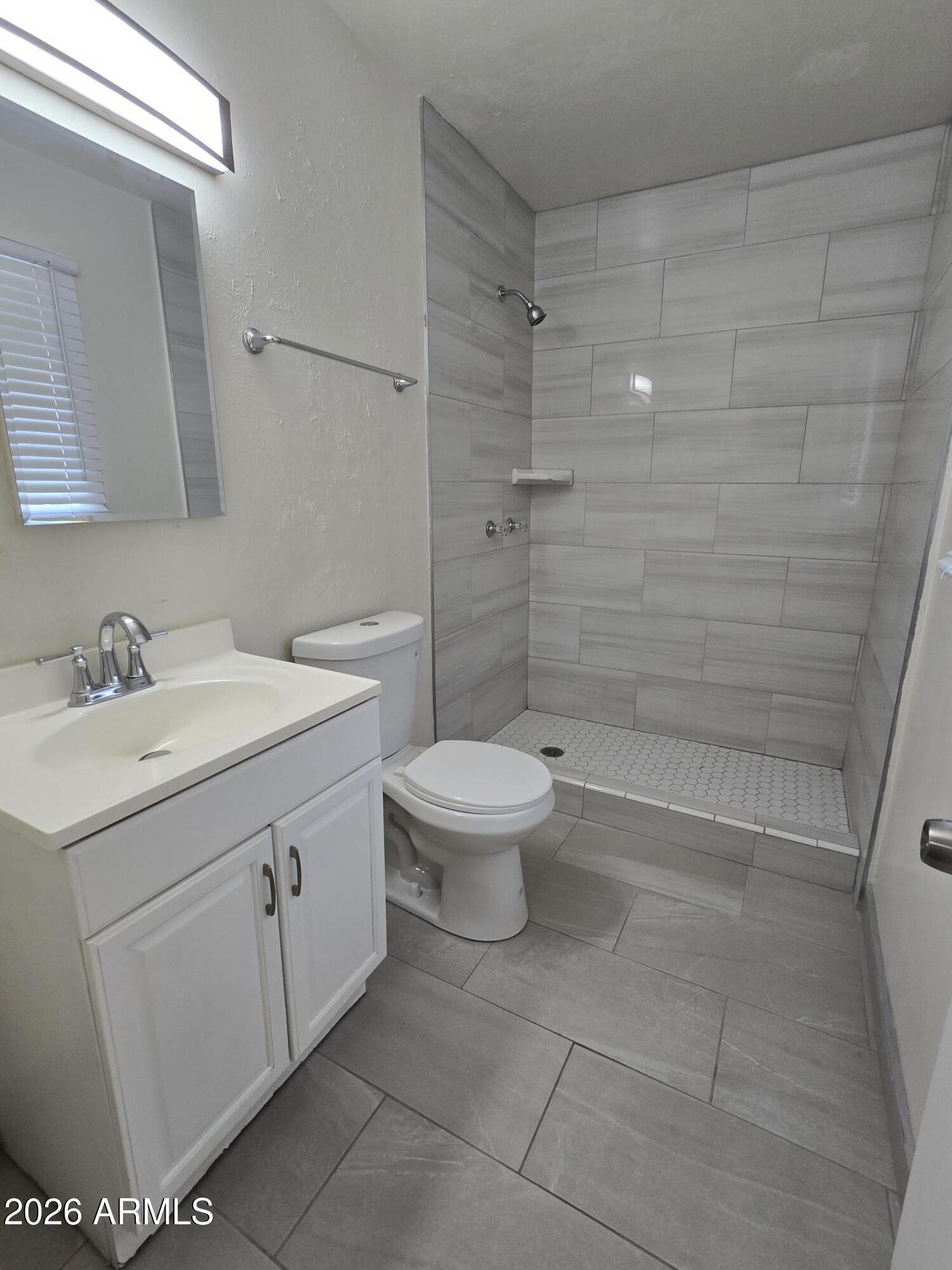 6512 North 41st Avenue Phoenix, AZ 85019 - Photo 21 of 24 a bathroom with a sink toilet and shower