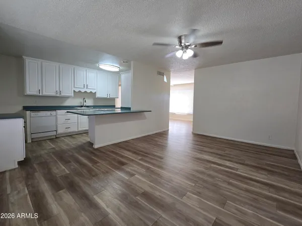 a view of a kitchen with microwave and cabinets