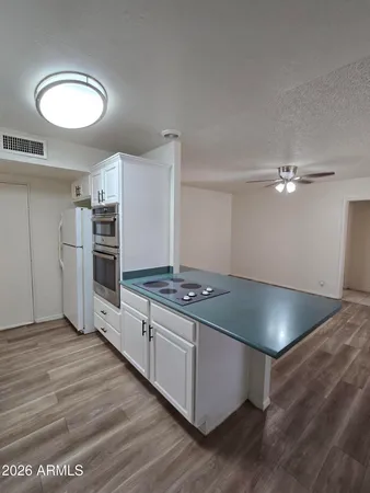 a kitchen with stainless steel appliances a refrigerator sink and cabinets