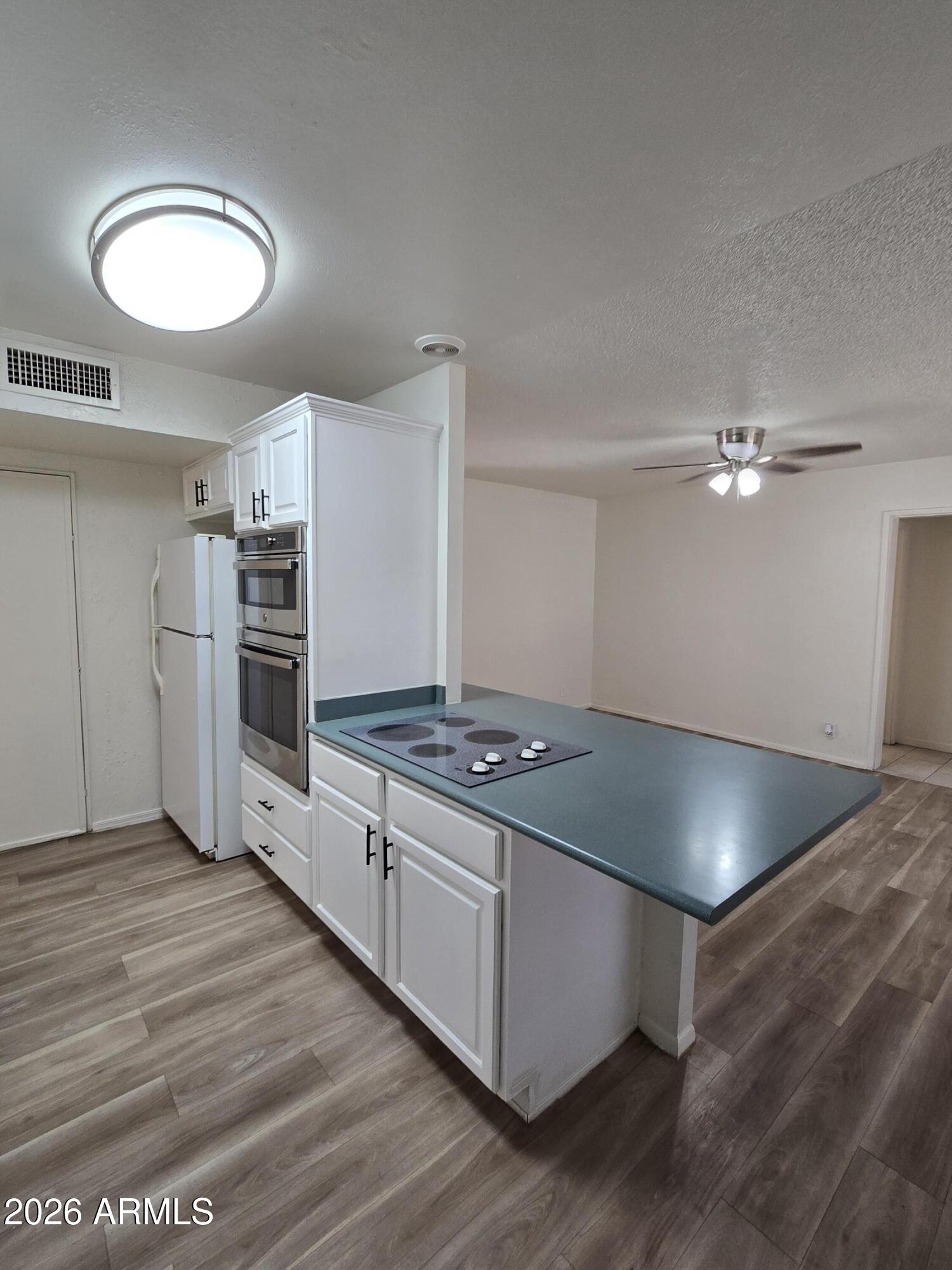 6512 North 41st Avenue Phoenix, AZ 85019 - Photo 10 of 24 a kitchen with stainless steel appliances granite countertop a stove a refrigerator and a sink