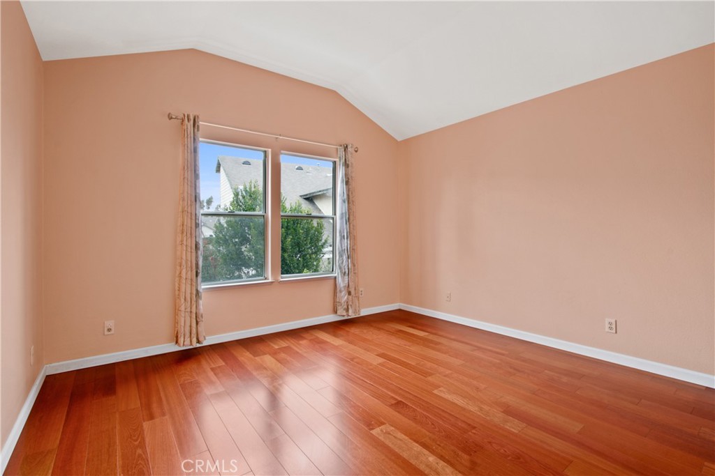 3117 Antler Road Ontario, CA 91761 - Photo 11 of 16 a view of an empty room with wooden floor and a window