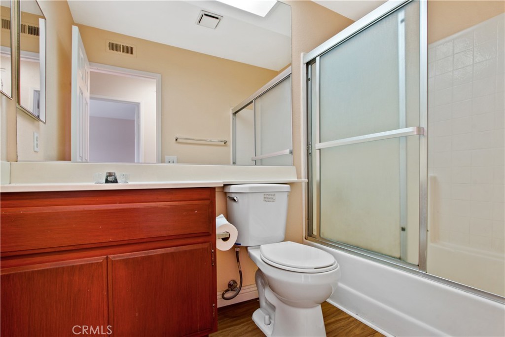 3117 Antler Road Ontario, CA 91761 - Photo 13 of 16 a bathroom with a toilet a sink and mirror