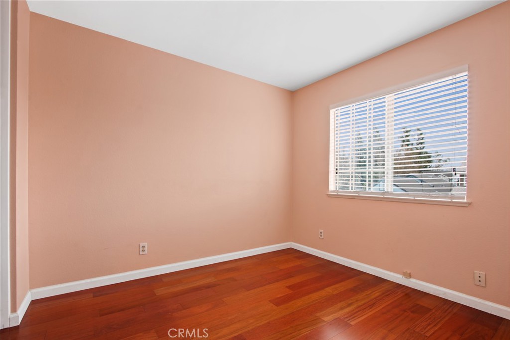 3117 Antler Road Ontario, CA 91761 - Photo 8 of 16 a view of an empty room with wooden floor and a window