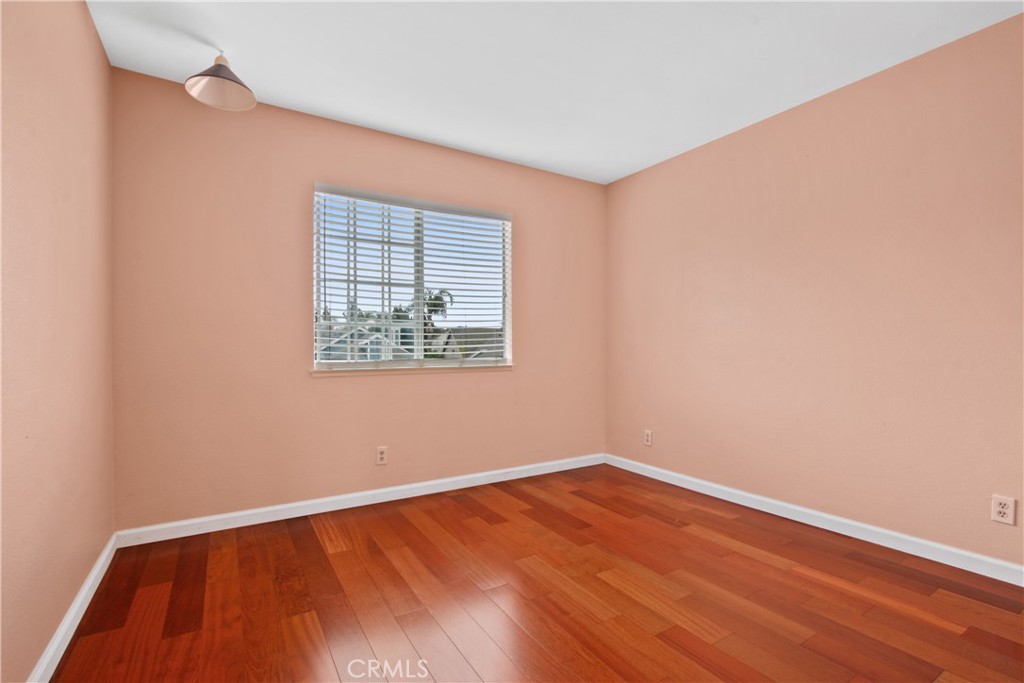 3117 Antler Road Ontario, CA 91761 - Photo 9 of 16 an empty room with wooden floor and windows