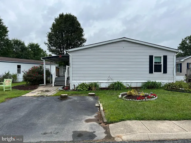a front view of a house with a garden and patio
