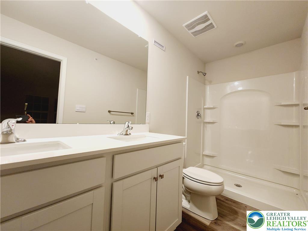 1104 Martin Road Breinigsville, PA 18031 - Photo 23 of 30 a bathroom with a sink toilet vanity and shower