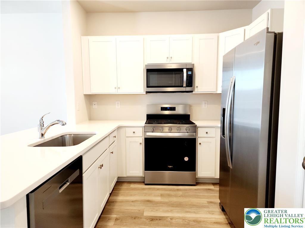 1104 Martin Road Breinigsville, PA 18031 - Photo 8 of 30 a kitchen with stainless steel appliances a refrigerator sink and microwave