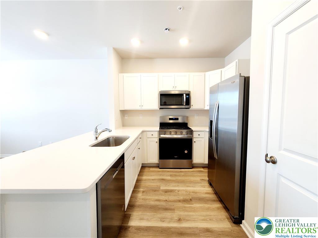 1104 Martin Road Breinigsville, PA 18031 - Photo 9 of 30 a kitchen with a sink a counter top space and stainless steel appliances