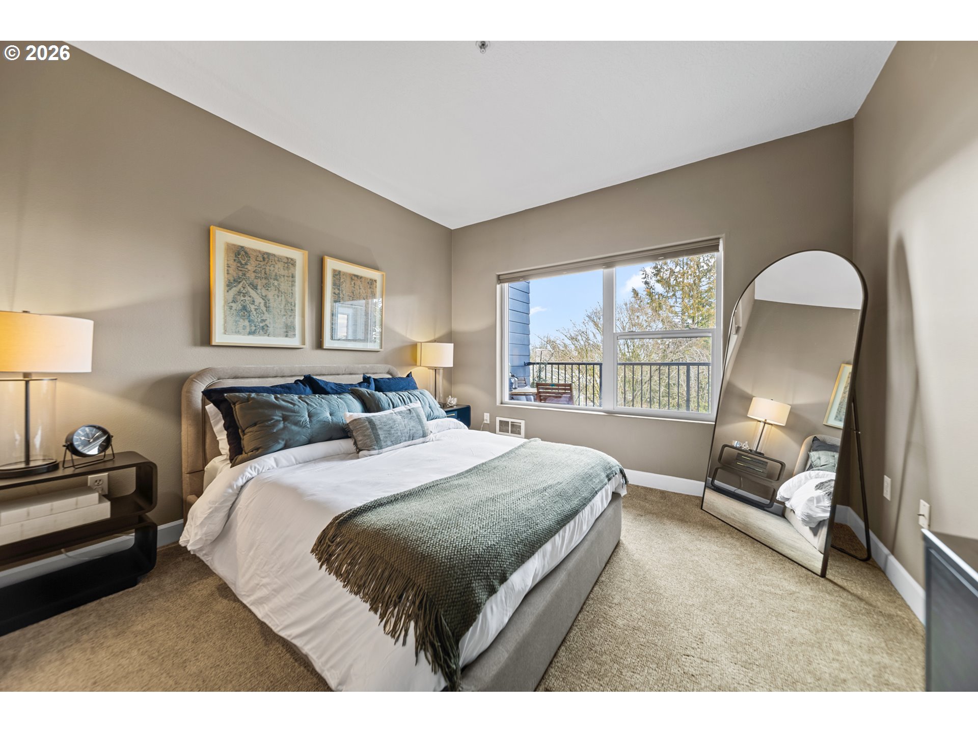 614 South Nevada Street, Unit B Portland, OR 97219 - Photo 19 of 29 a bedroom with a large bed and a large window