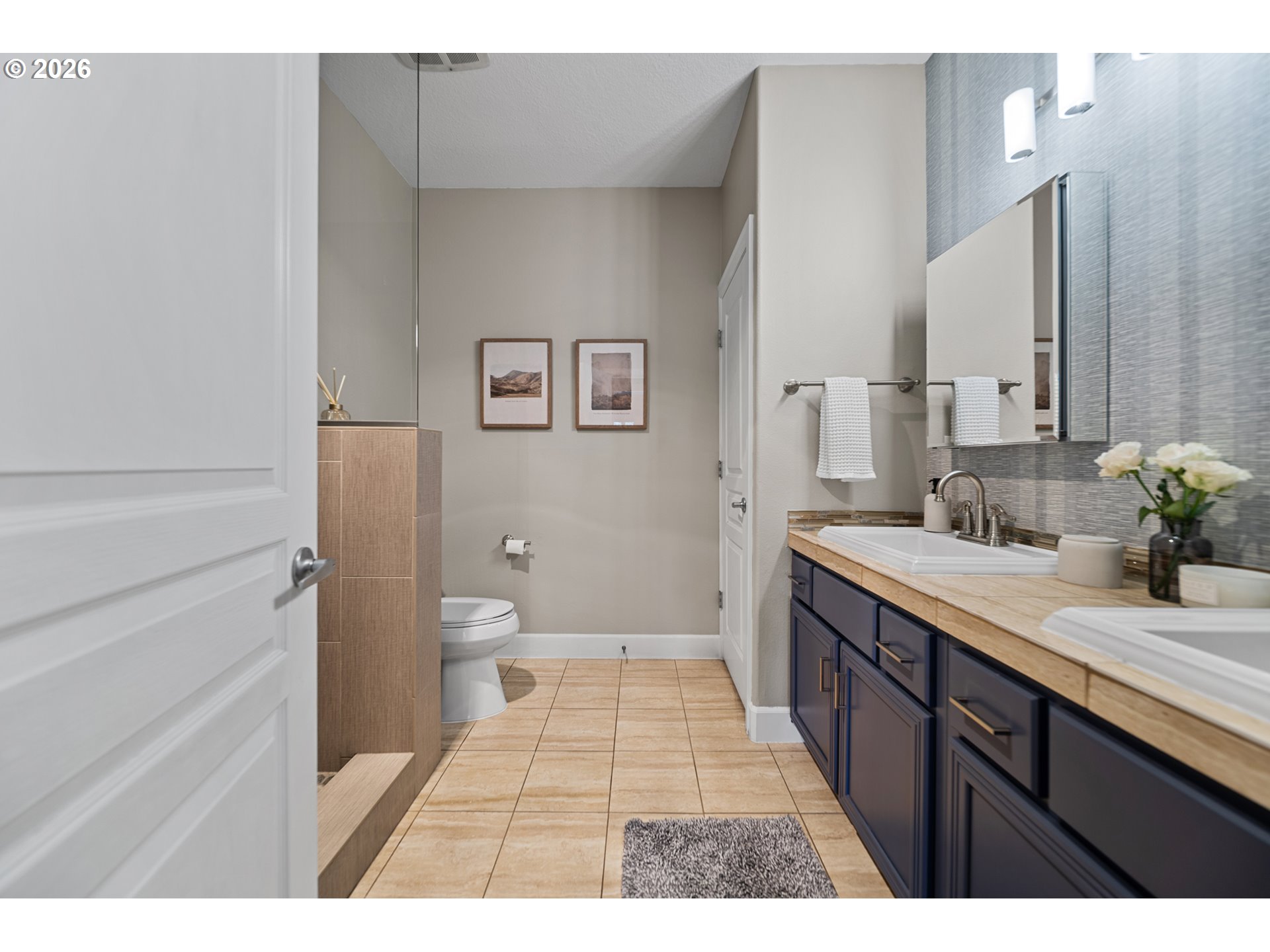 614 South Nevada Street, Unit B Portland, OR 97219 - Photo 20 of 29 a spacious bathroom with a granite countertop sink a toilet a mirror and shower