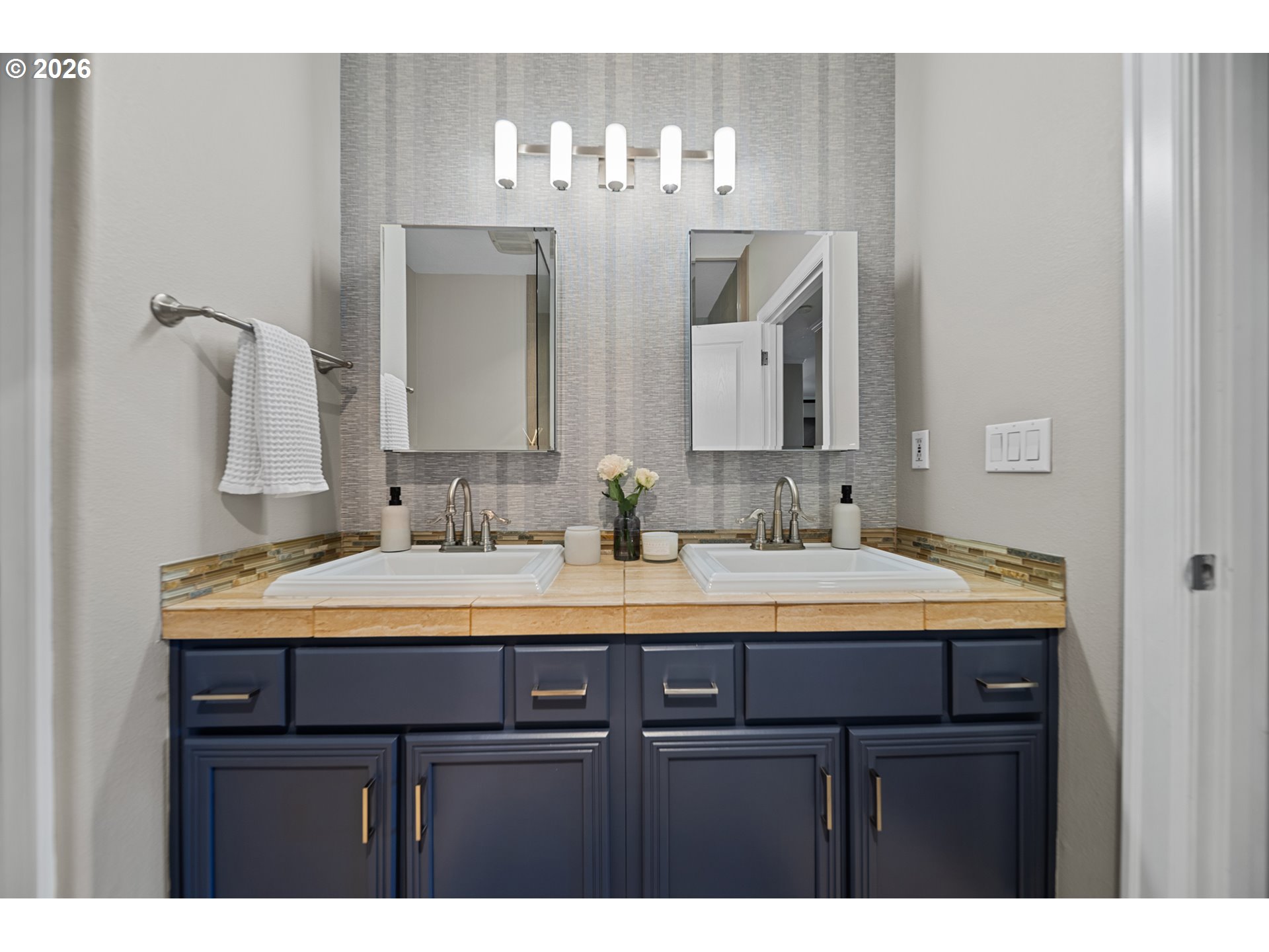 614 South Nevada Street, Unit B Portland, OR 97219 - Photo 21 of 29 a bathroom with a double vanity sink and a mirror
