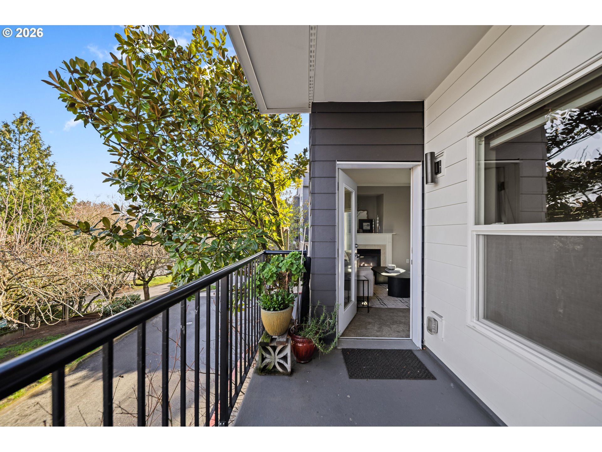 614 South Nevada Street, Unit B Portland, OR 97219 - Photo 26 of 29 a balcony with wooden floor and outdoor seating